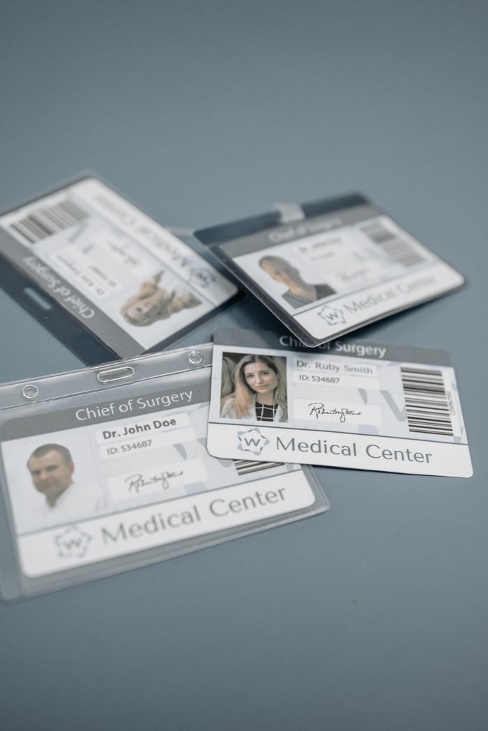 Close-up of medical ID badges featuring doctors from a healthcare center.